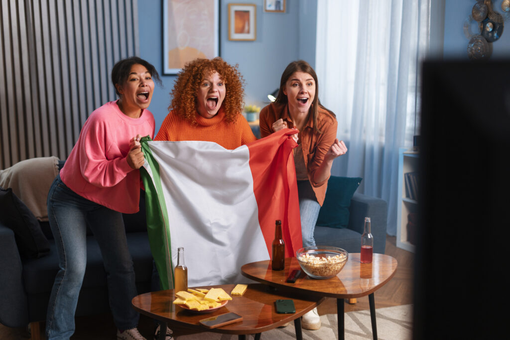 A group of women celebrating as the Mexican team wins the soccer game.