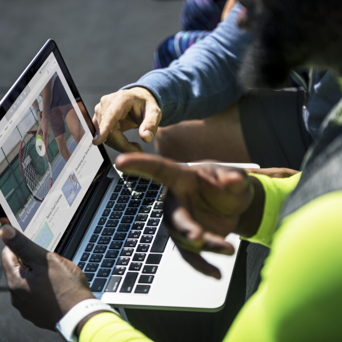 a-marketing-team-analyzing-video-search-results-for-tennis-tutorials-on-laptop