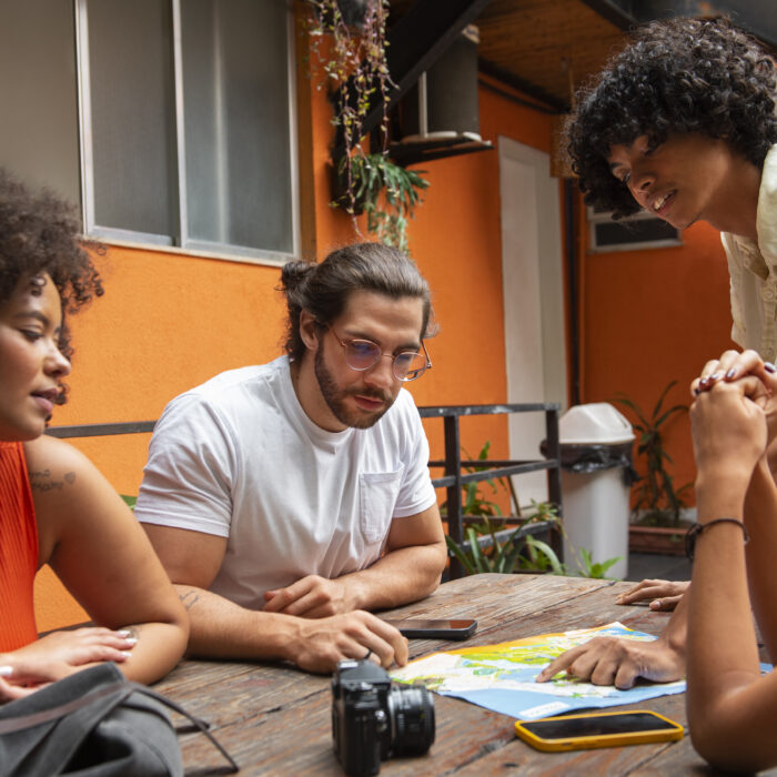 diverse-group-of-friends-planning-a-trip-with-a-map-for-social-impact-pr