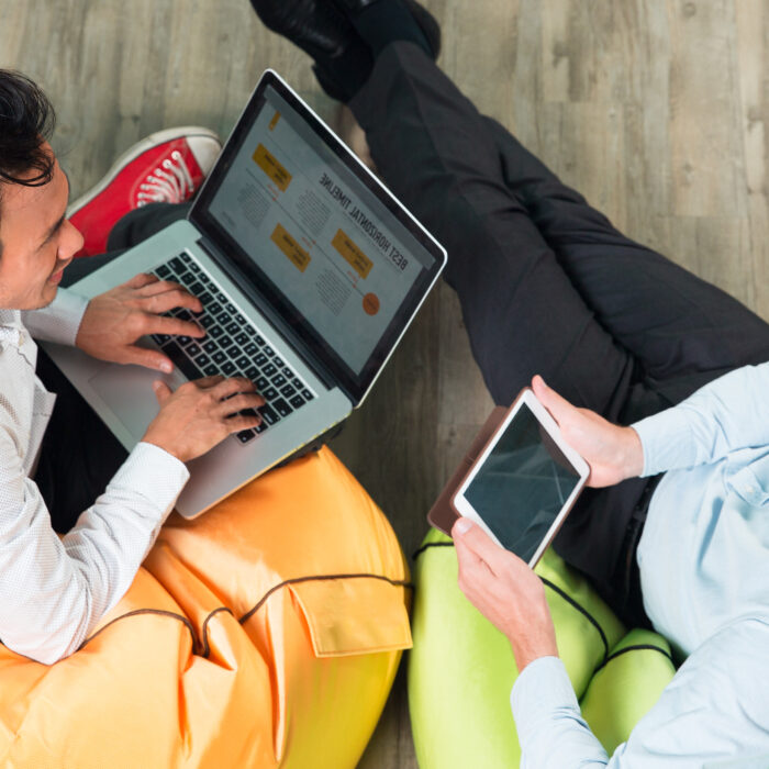 two-professionals-working-on-laptop-and-tablet-for-SEO-link-building-in-Chile