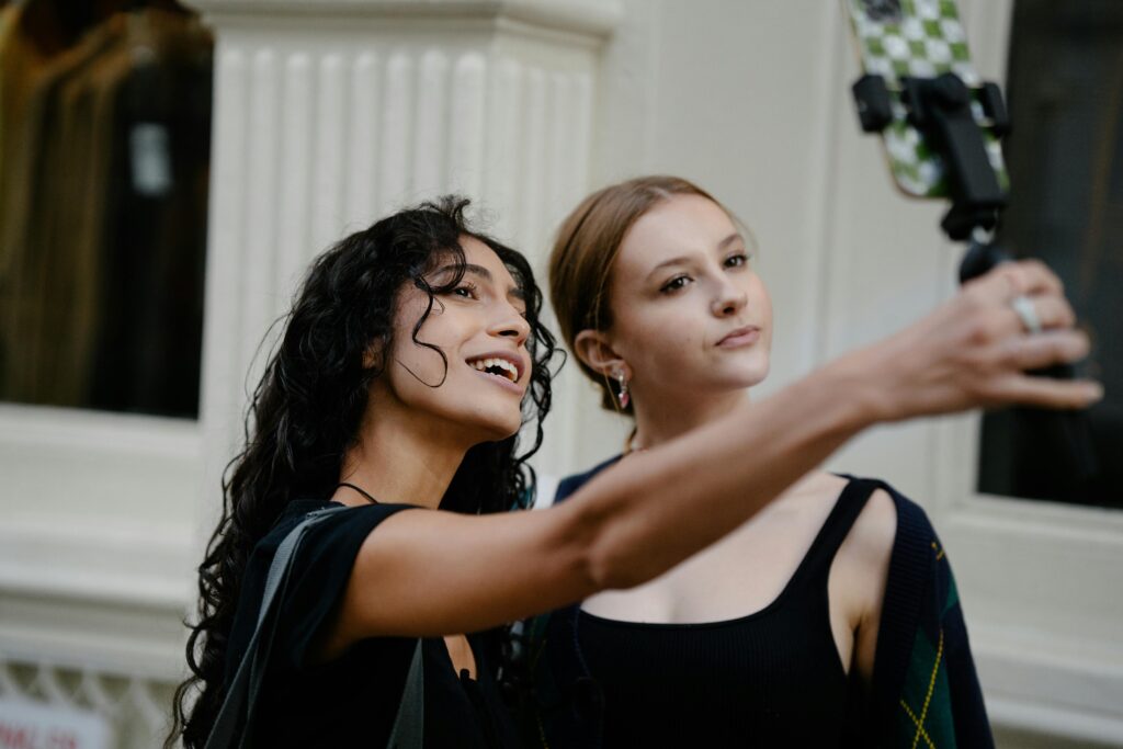 Two women taking a selfie for their Instagram account