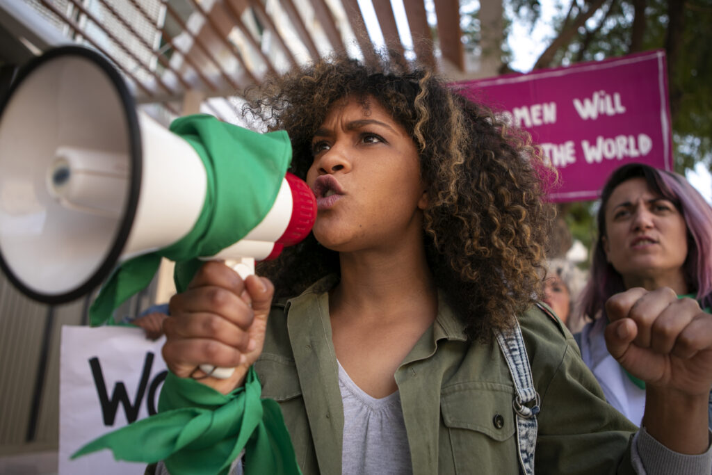 A woman marching during the crisis communication in Latam